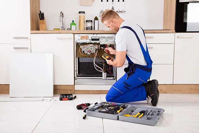 Technician testing the internal components of a residential oven
